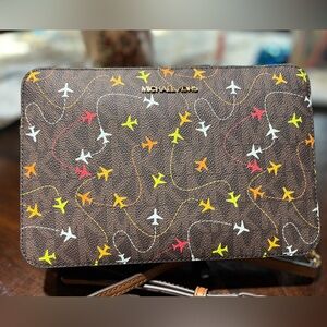 New Michael Kors Brown Crossbody with Airplane Design great for Christmas